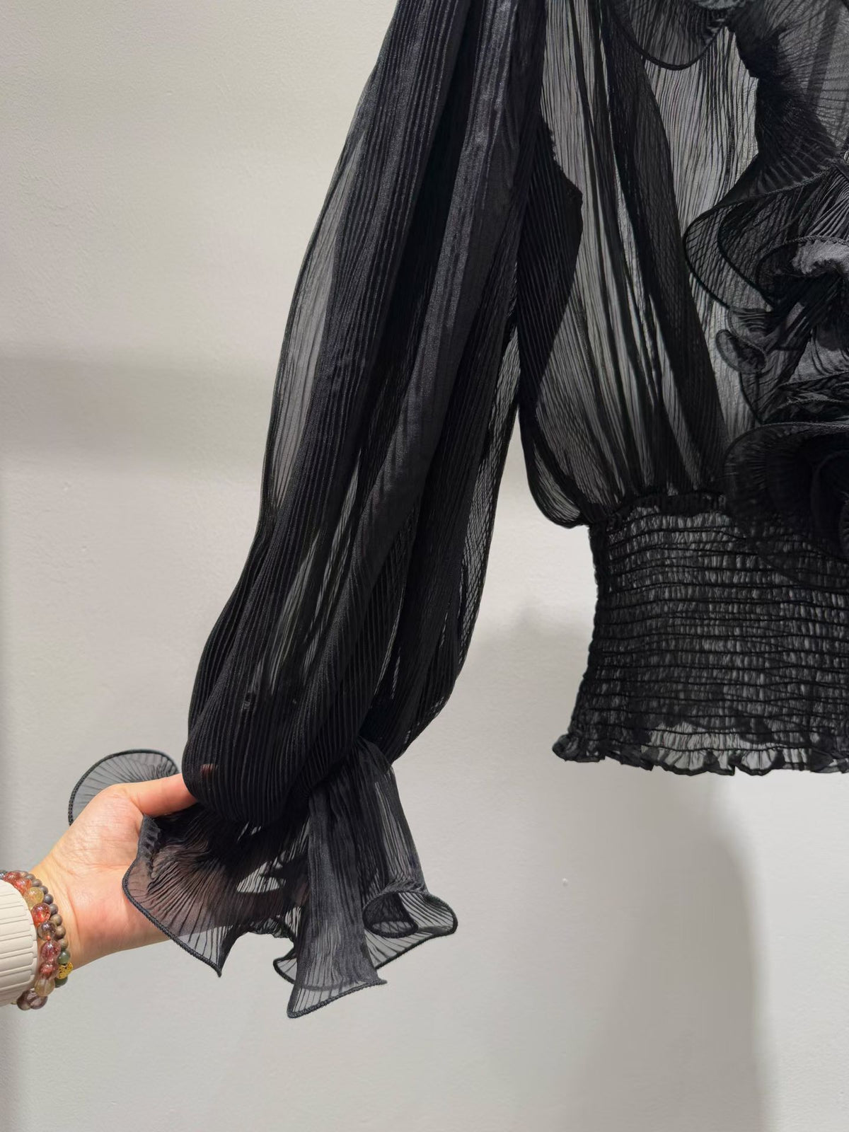 Black blouse sleeve and smocked waist detail