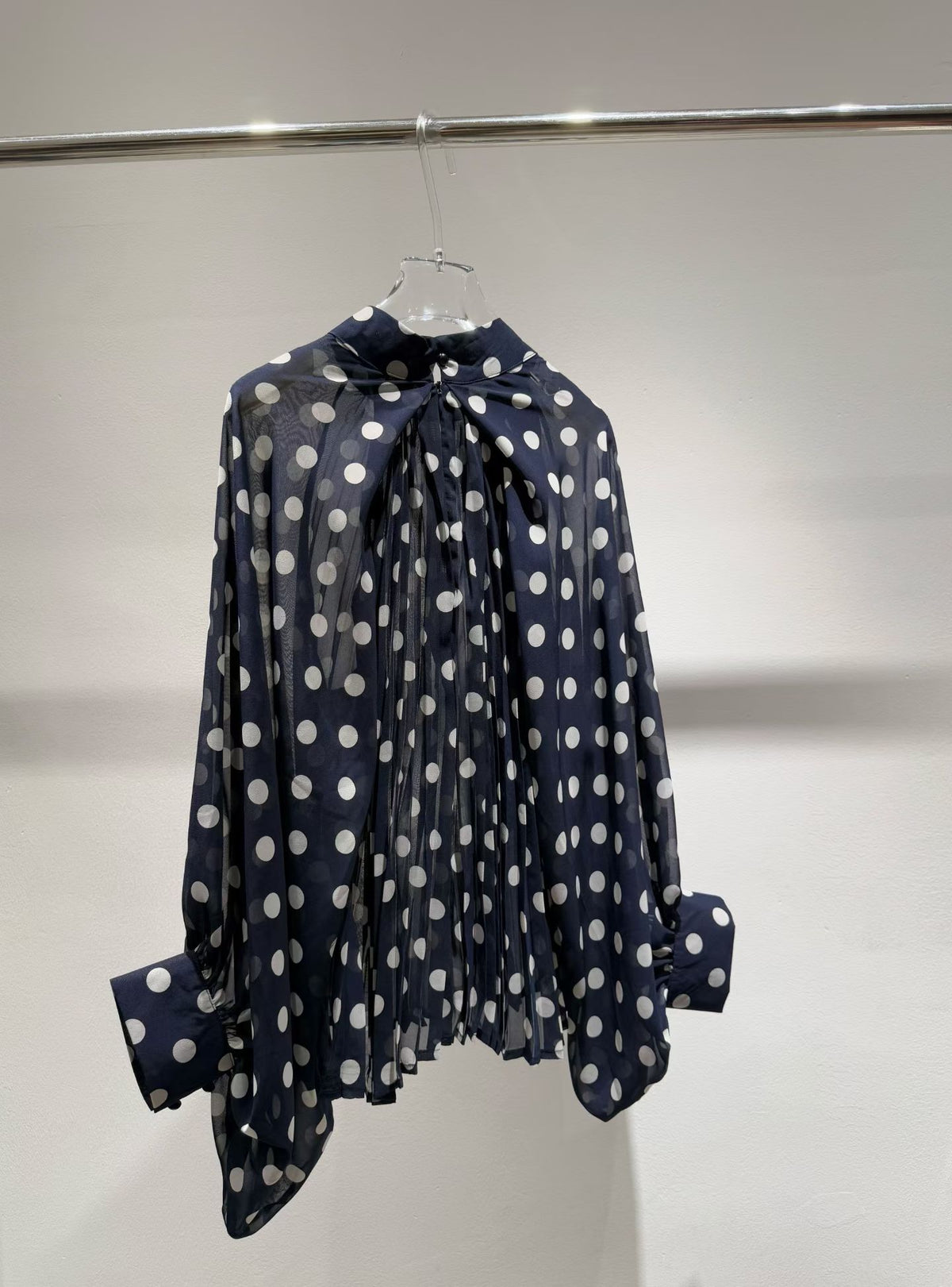 Navy blue polka dot blouse back view