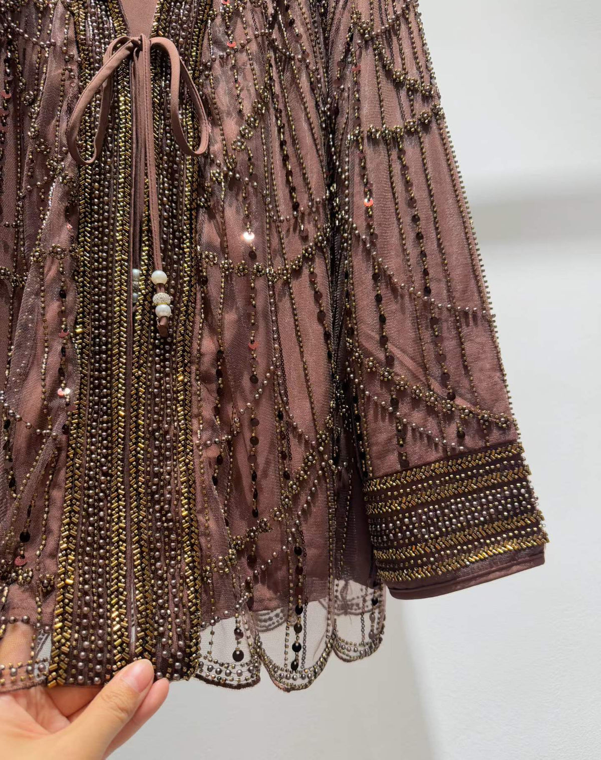 Brown jacket beadwork, cuff and scalloped hem detail