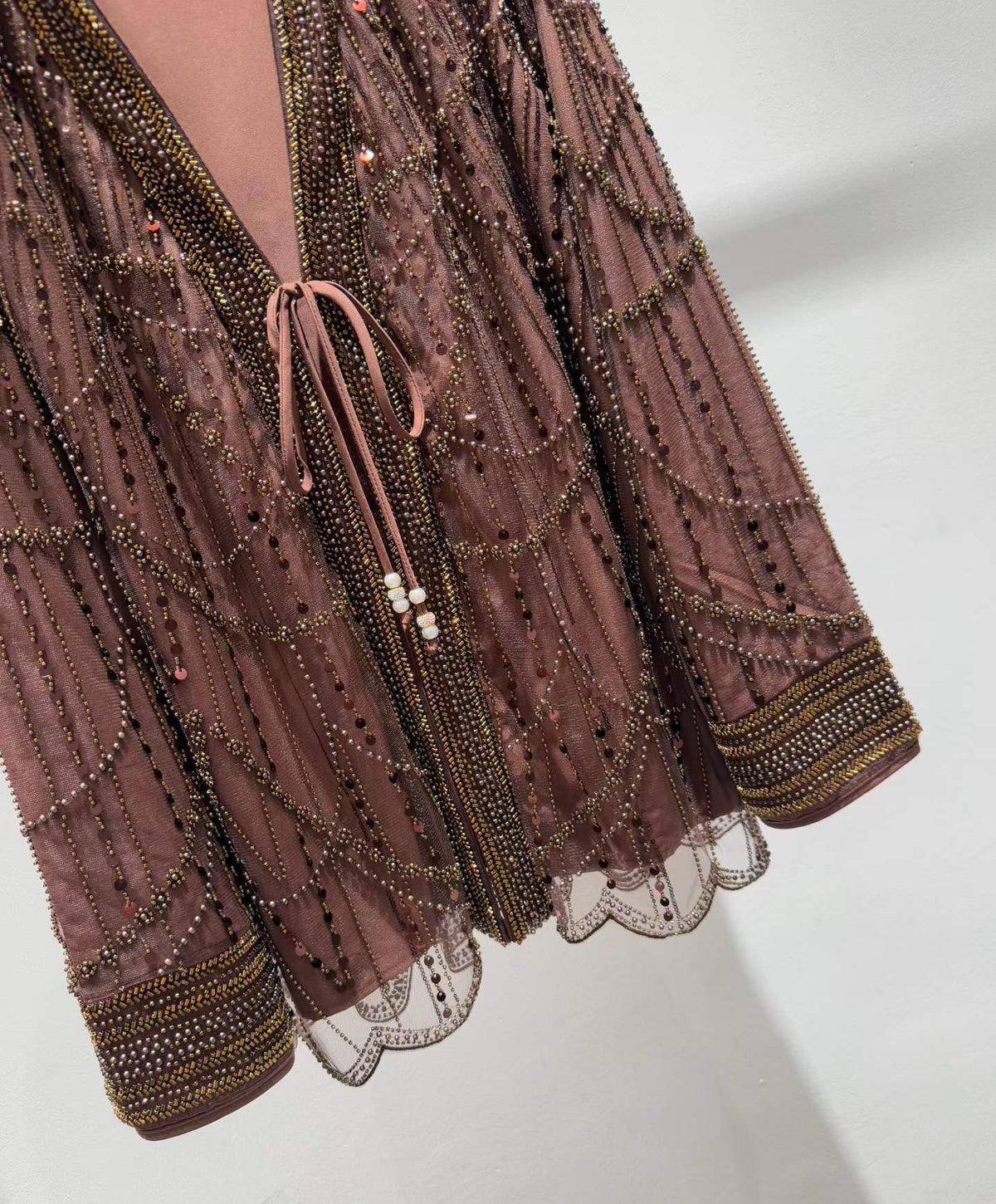 Brown jacket beadwork and tie-front close-up