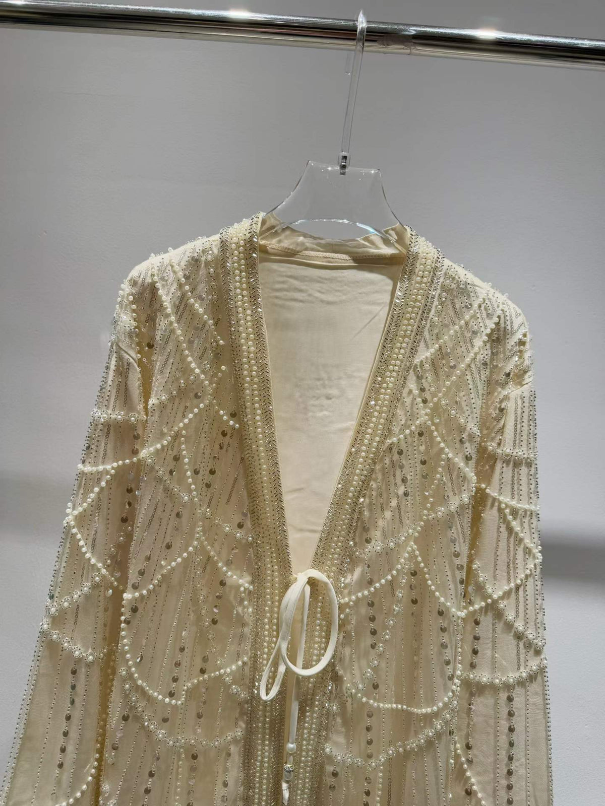 Ivory jacket neckline and tie-front detail