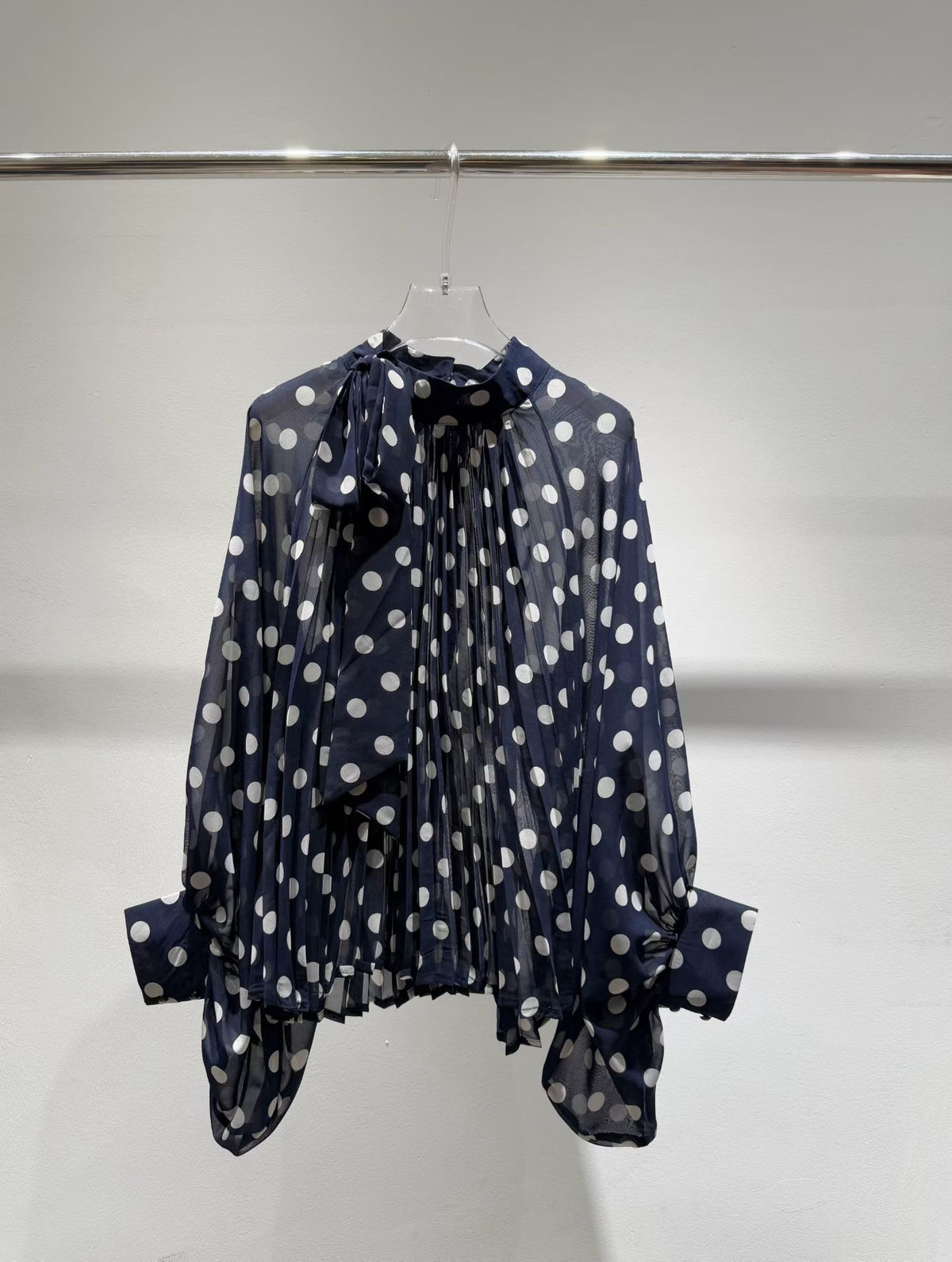 Navy blue polka dot blouse front view