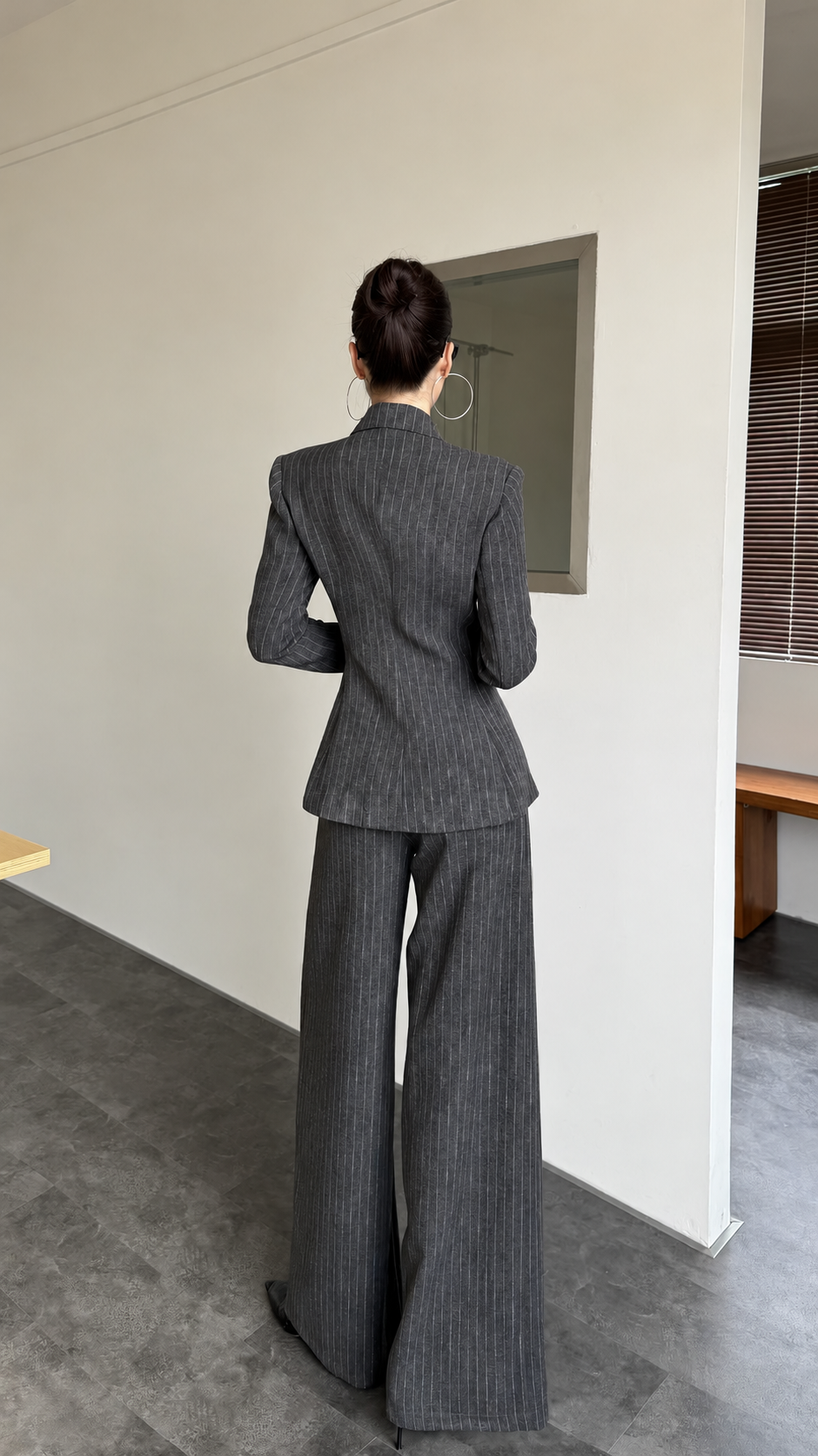 Charcoal pinstripe blazer and wide-leg trouser suit shown from the back