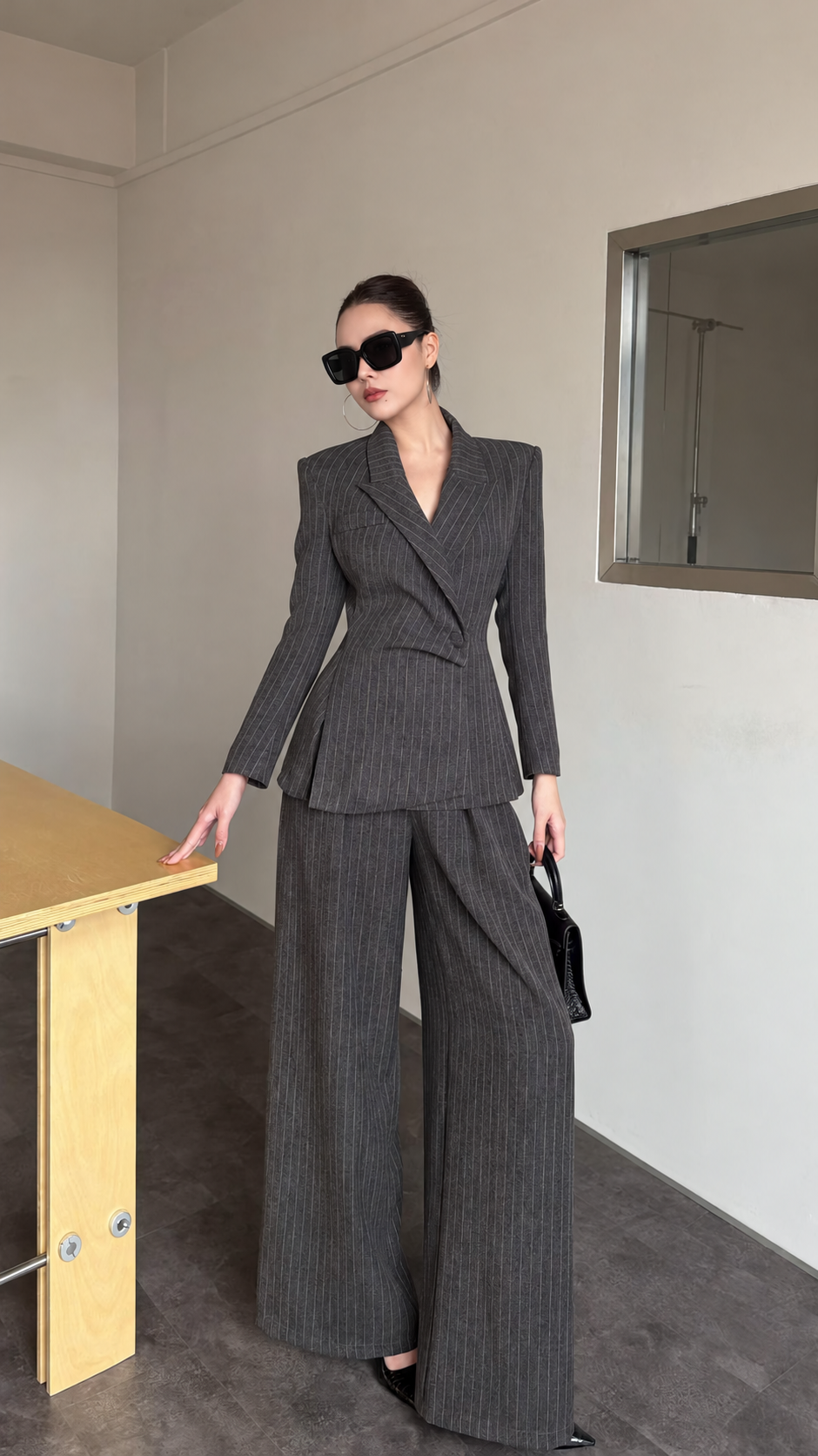 Charcoal pinstripe blazer and wide-leg trouser suit shown from the front
