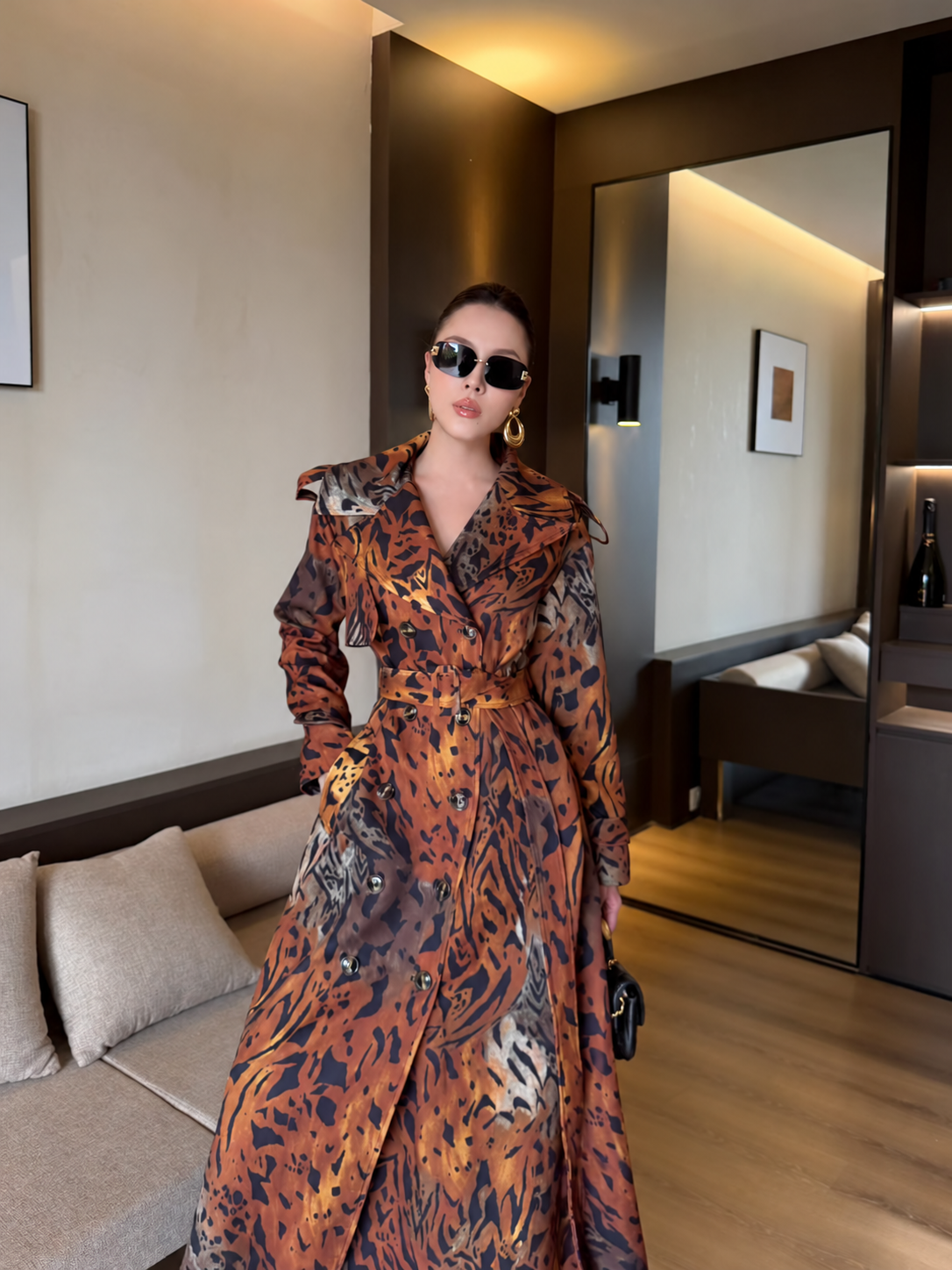 Closer front view of rust multi maxi trench coat with wide lapels and double-breasted buttons