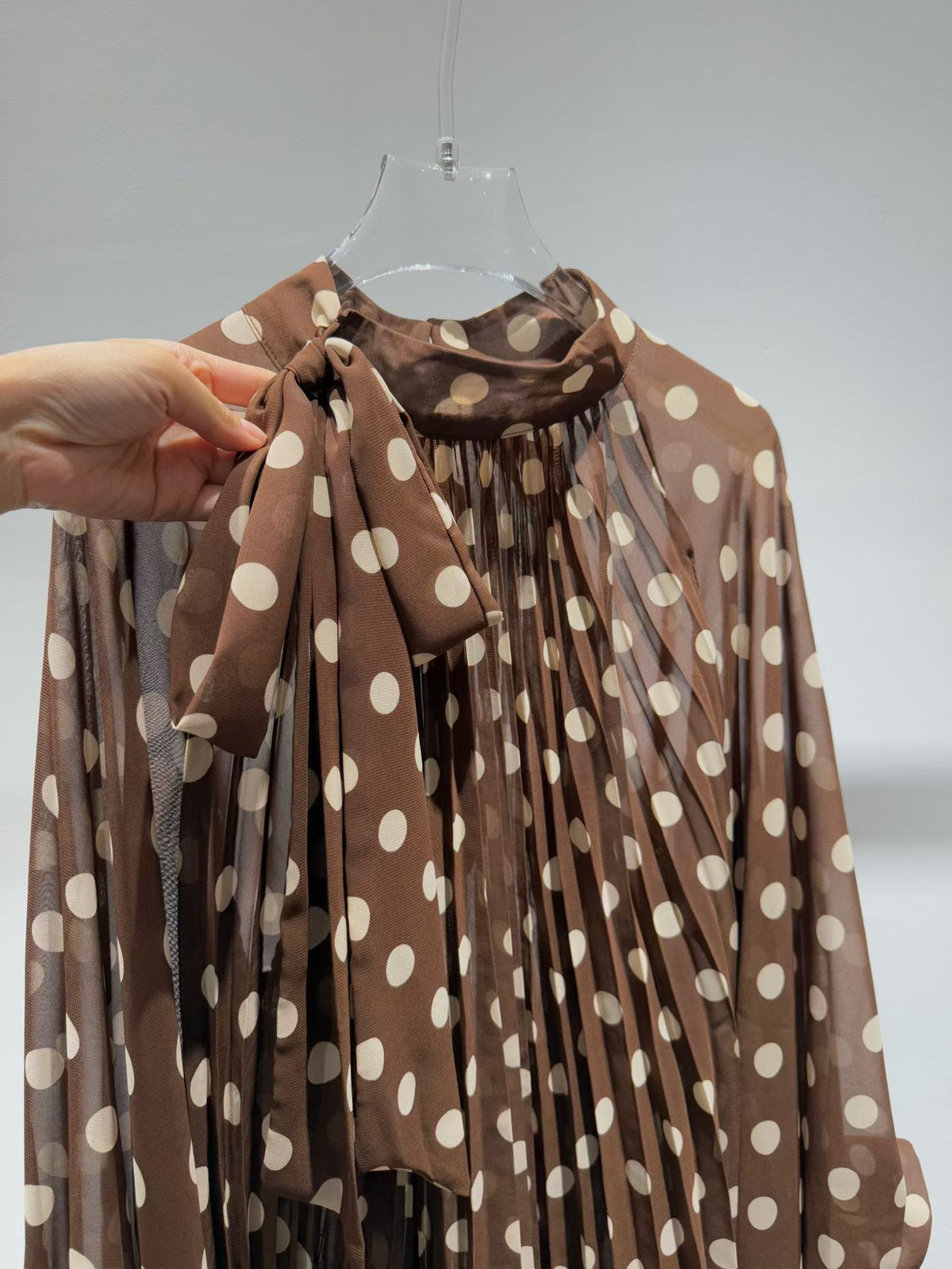 Brown polka dot blouse bow and neckline detail