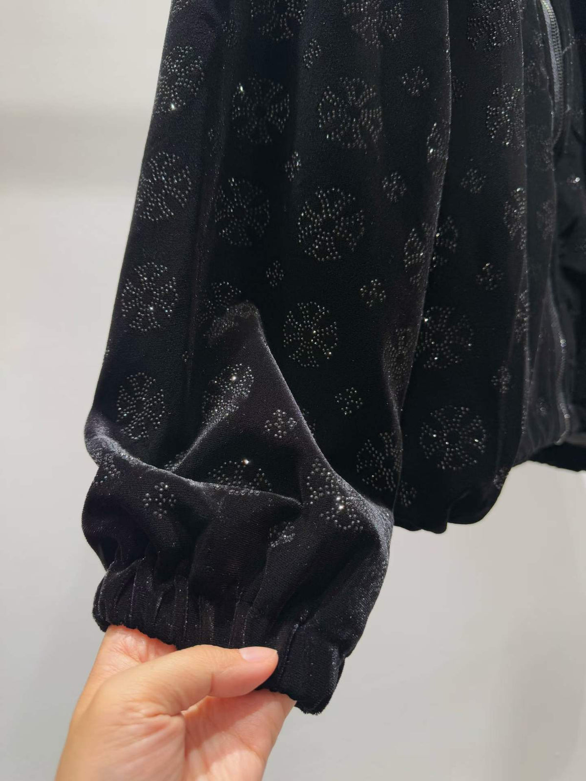 Black floral sparkle hooded zip-front jacket, cuff detail