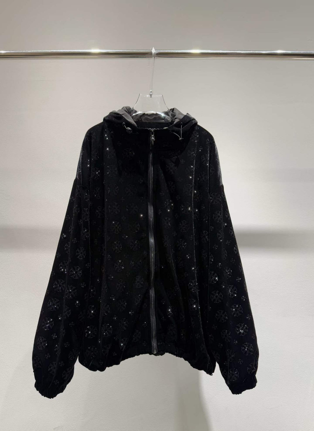 Black floral sparkle hooded zip-front jacket, front