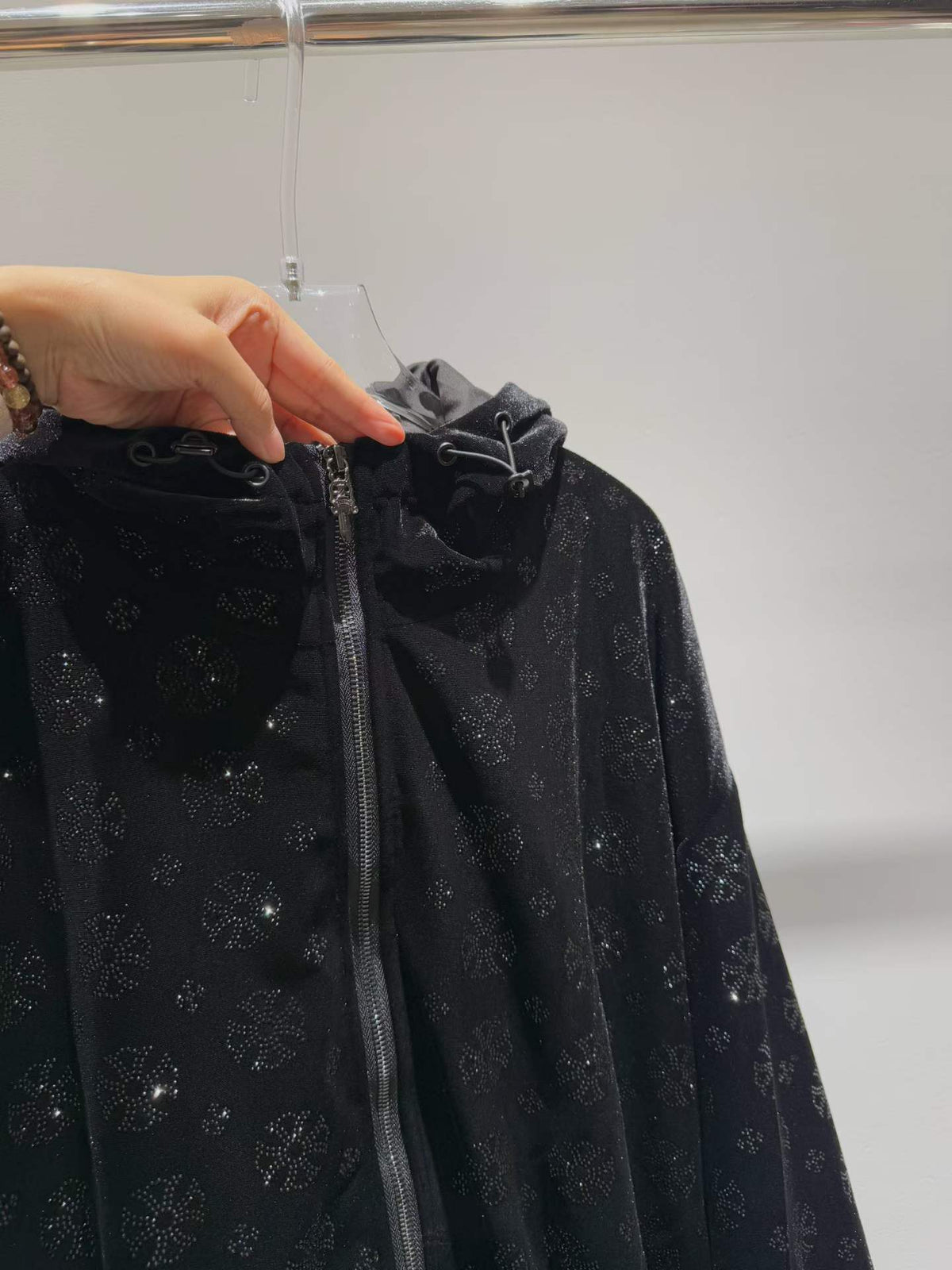 Black floral sparkle hooded zip-front jacket, hood detail