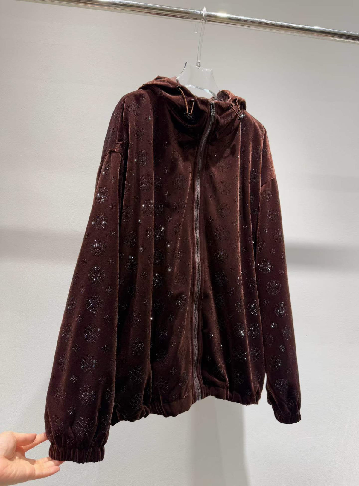 Brown floral sparkle hooded zip-front jacket, angled front