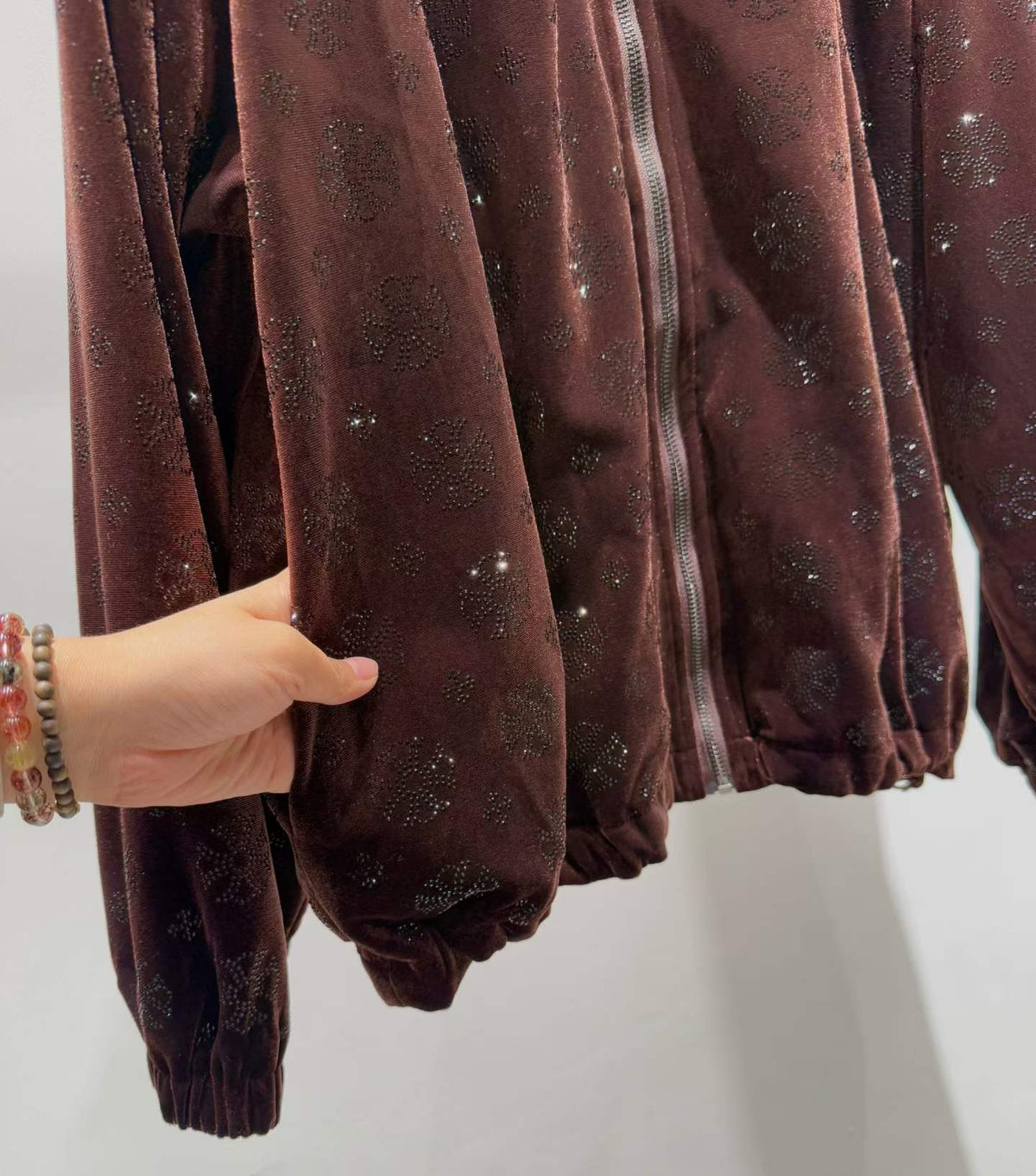 Brown floral sparkle hooded zip-front jacket, sleeve detail