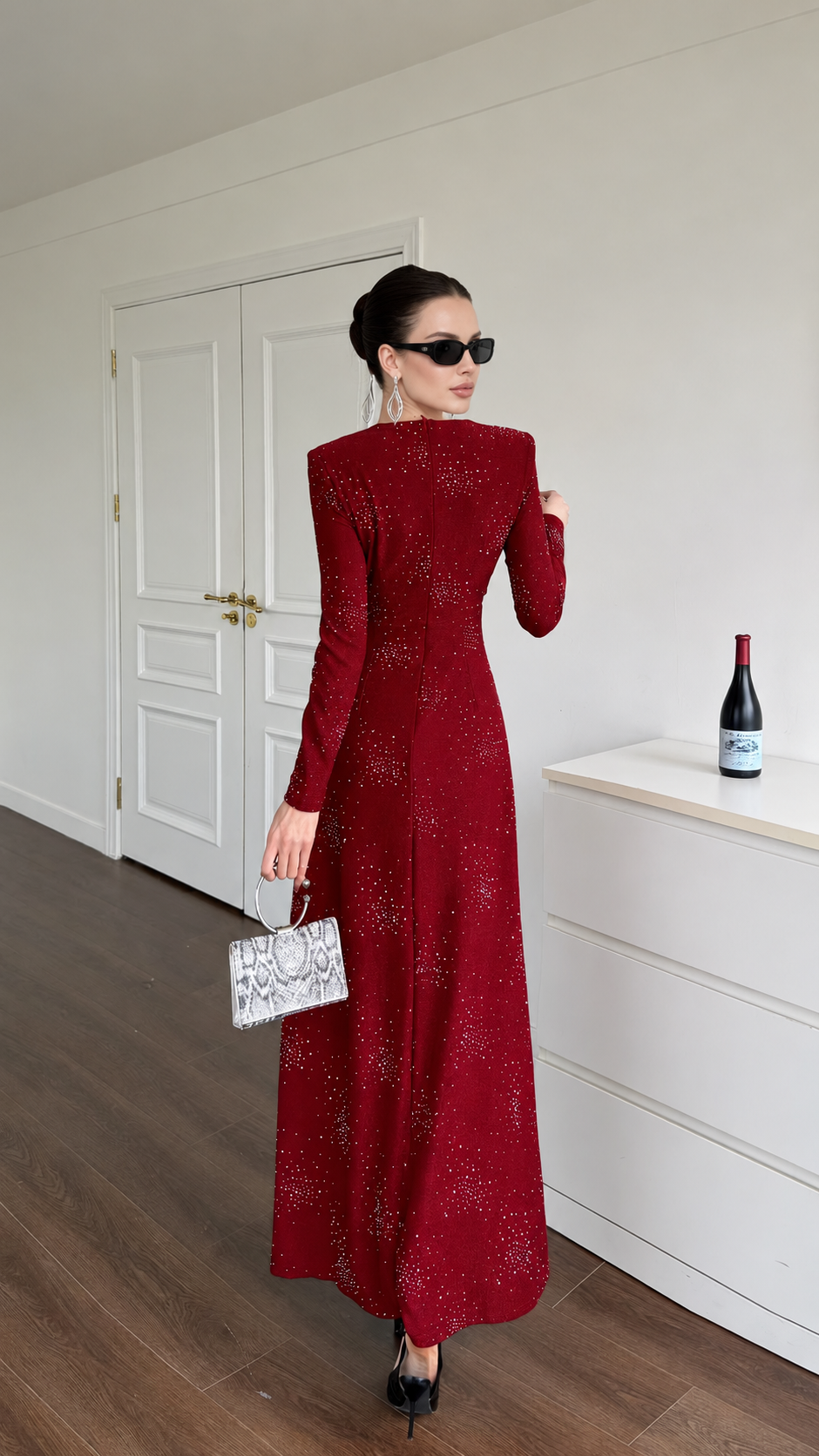Back view of the burgundy long-sleeved embellished maxi dress in a full-length silhouette.