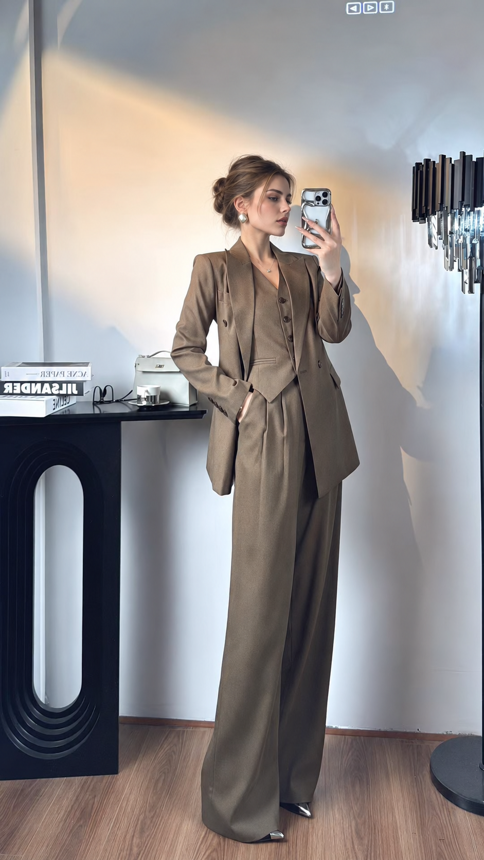 Women's brown three-piece suit with double-breasted blazer, angled front view